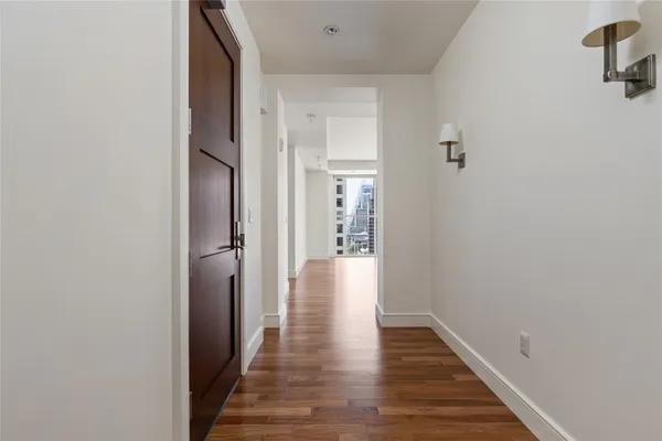 a view of a hallway with wooden floor