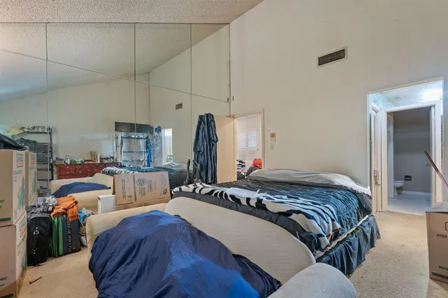 a bedroom with bed and window