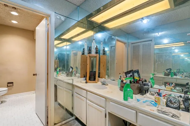 a bathroom with a sink mirror and vanity