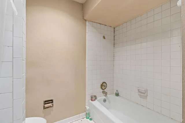 a bathroom with a bathtub and a toilet