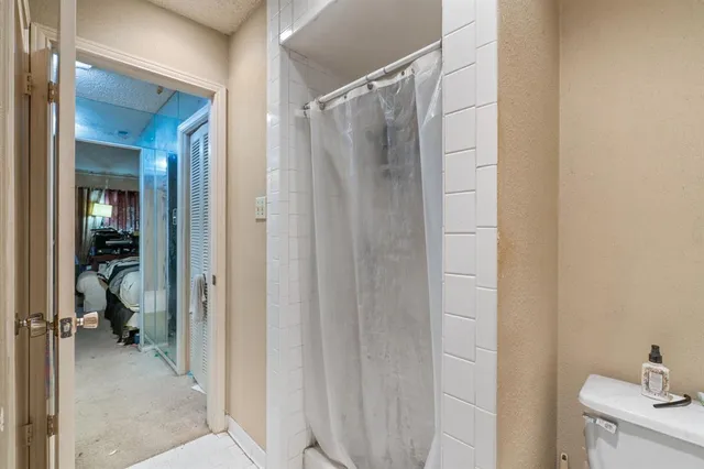 a bathroom with a shower and a sink