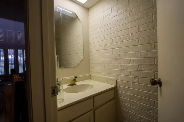 a bathroom with a sink shower and a mirror