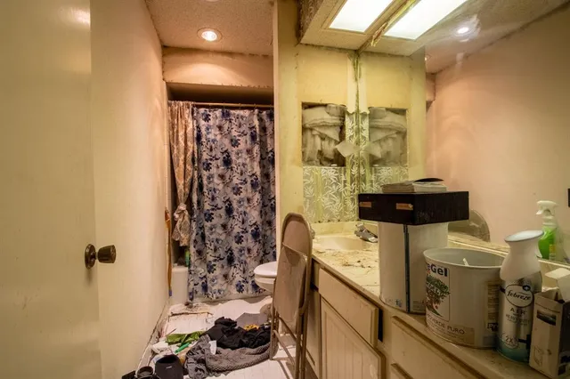 a bathroom with a sink toilet and shower