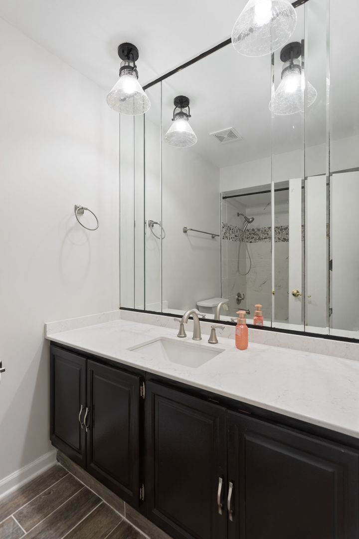 1031 Conrad Court Elk Grove Village, IL 60007 - Photo 13 of 17 a bathroom with a double vanity sink and mirror