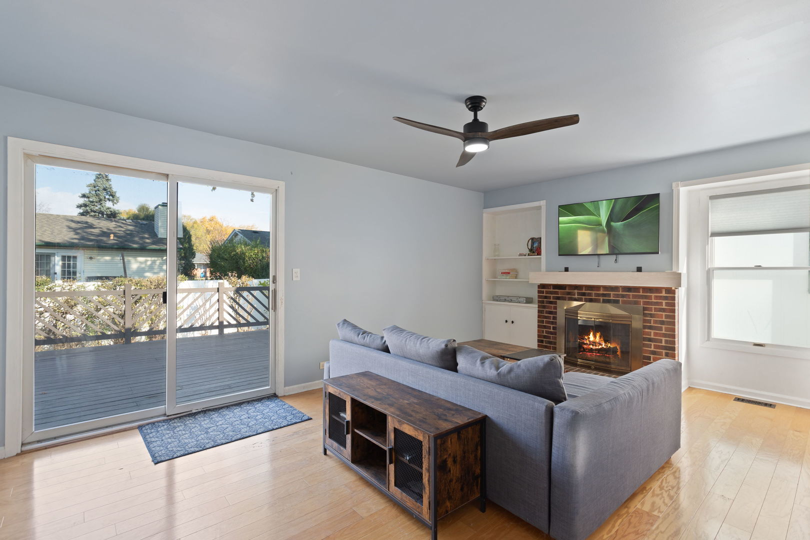 1031 Conrad Court Elk Grove Village, IL 60007 - Photo 8 of 17 a living room with furniture a fireplace and a floor to ceiling window