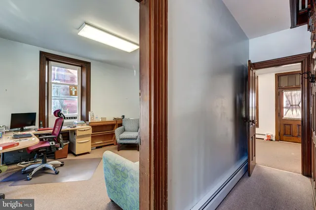 a living room with furniture a large window and a potted plant