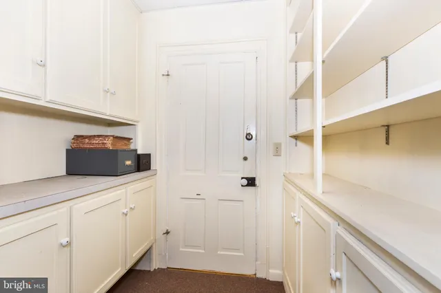 an empty room with windows and closet