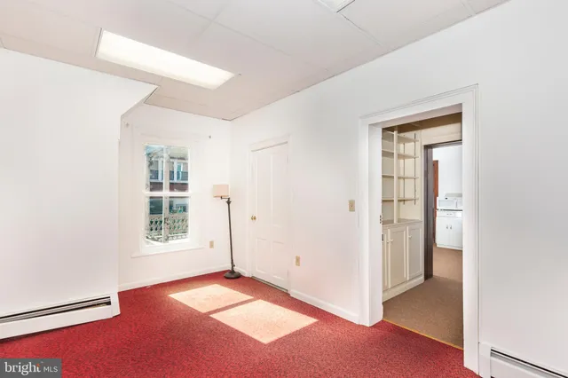 a room with a window and mirror