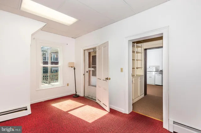 a kitchen with stainless steel appliances a refrigerator and a window
