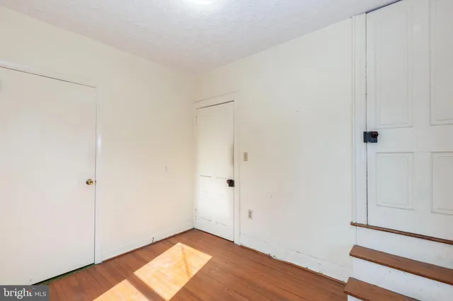 a front view of a house with a garden and yard