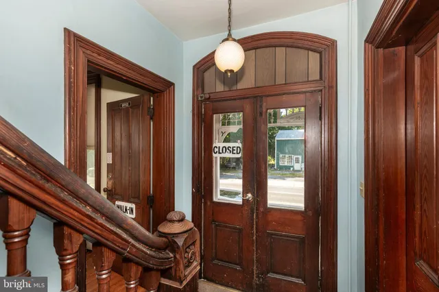 a living room with furniture and two windows