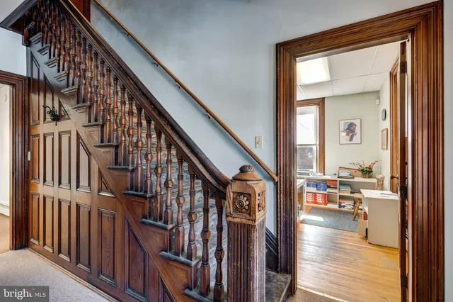 a living room with furniture and large windows