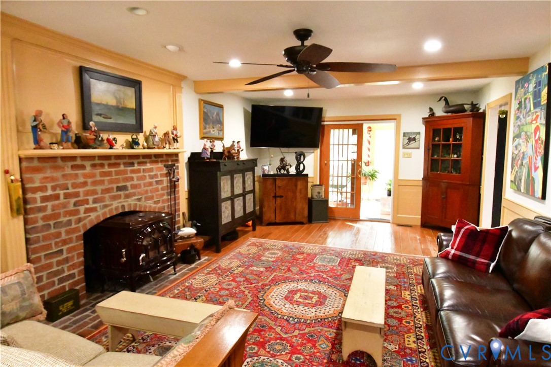 9101 Woodpecker Road Chesterfield, VA 23838 - Photo 11 of 50 a living room with furniture a flat screen tv and a fireplace
