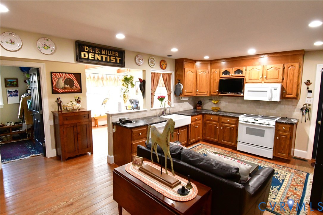 9101 Woodpecker Road Chesterfield, VA 23838 - Photo 16 of 50 a kitchen with stainless steel appliances kitchen island granite countertop a stove a sink and a microwave