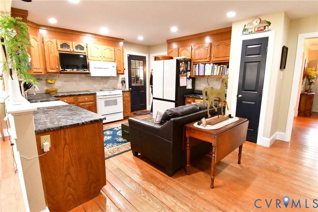 9101 Woodpecker Road Chesterfield, VA 23838 - Photo 20 of 50 a kitchen with stainless steel appliances granite countertop a refrigerator a stove top oven and a sink