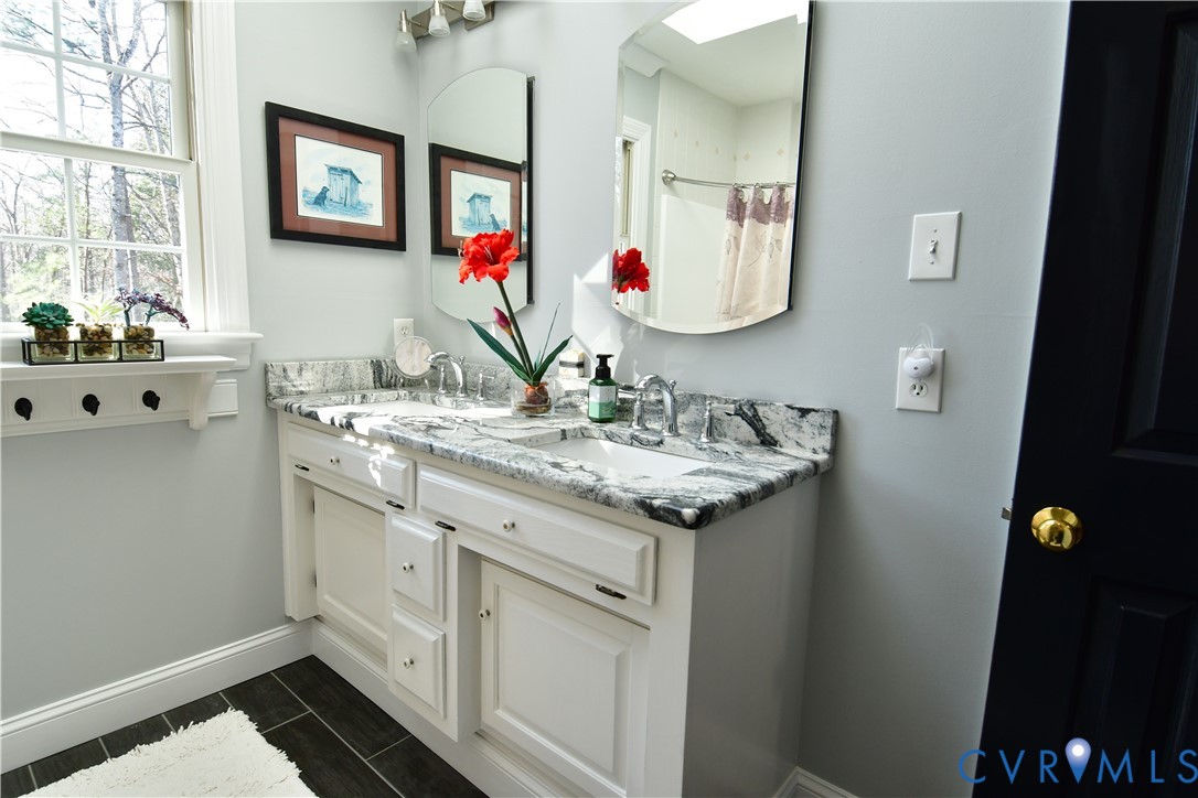 9101 Woodpecker Road Chesterfield, VA 23838 - Photo 29 of 50 a bathroom with a granite countertop double vanity sink and a mirror