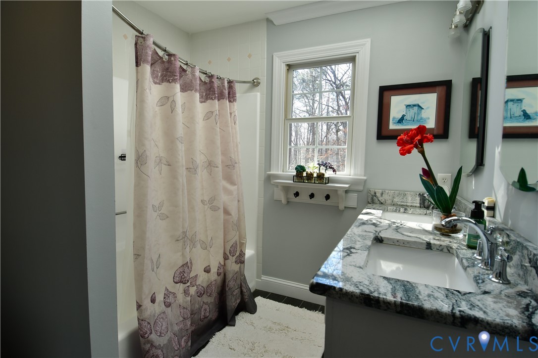 9101 Woodpecker Road Chesterfield, VA 23838 - Photo 30 of 50 Full bathroom with double vanity and shower / tub