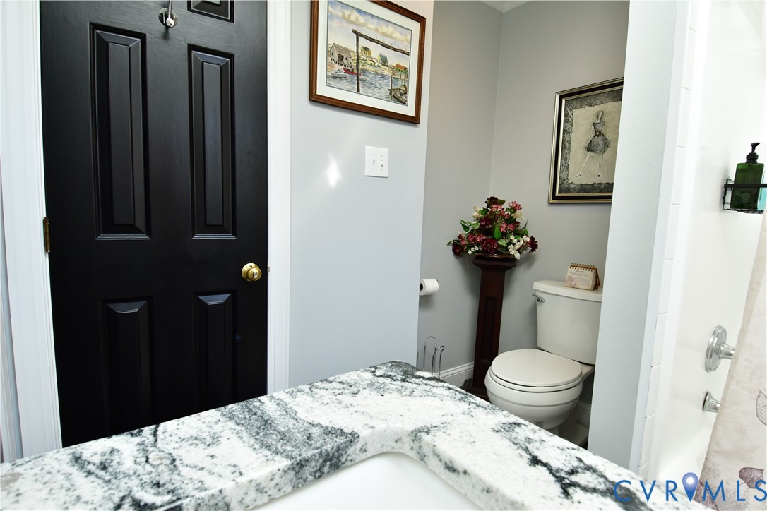 9101 Woodpecker Road Chesterfield, VA 23838 - Photo 31 of 50 a bedroom with a bed and a chandelier