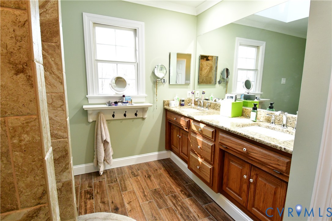 9101 Woodpecker Road Chesterfield, VA 23838 - Photo 35 of 50 a spacious bathroom with a granite countertop sink and a mirror