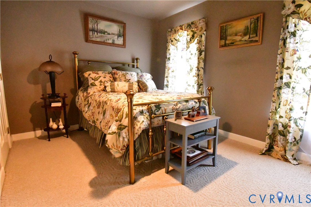 9101 Woodpecker Road Chesterfield, VA 23838 - Photo 39 of 50 a bed sitting in a bedroom next to a window