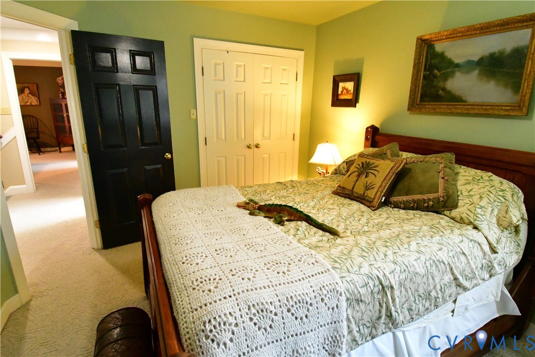 9101 Woodpecker Road Chesterfield, VA 23838 - Photo 42 of 50 a bedroom with a bed and wooden floor