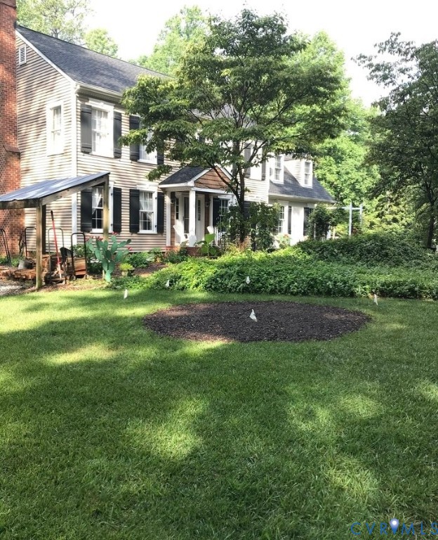 9101 Woodpecker Road Chesterfield, VA 23838 - Photo 9 of 50 a front view of a house with a garden