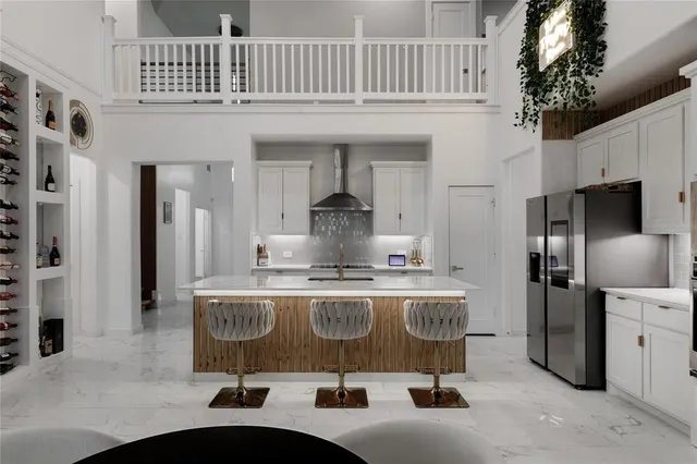 a kitchen with stainless steel appliances a sink a stove and refrigerator