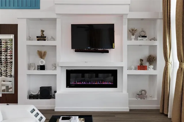 a living room with a fireplace and a flat screen tv
