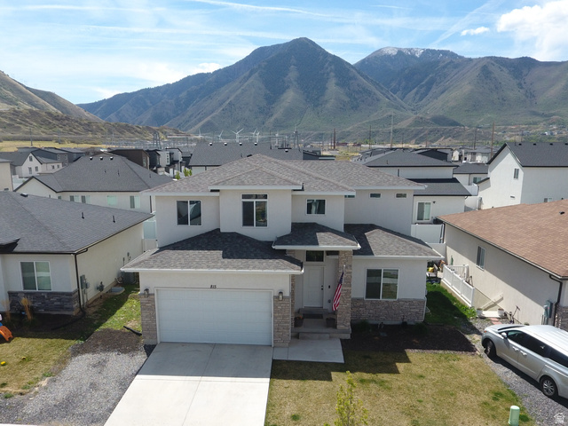 815 West Powderwood Lane Mapleton, UT 84664 - Photo 38 of 39 View of front facade with a residential view, a mountain view, driveway, a shingled roof, and stucco siding