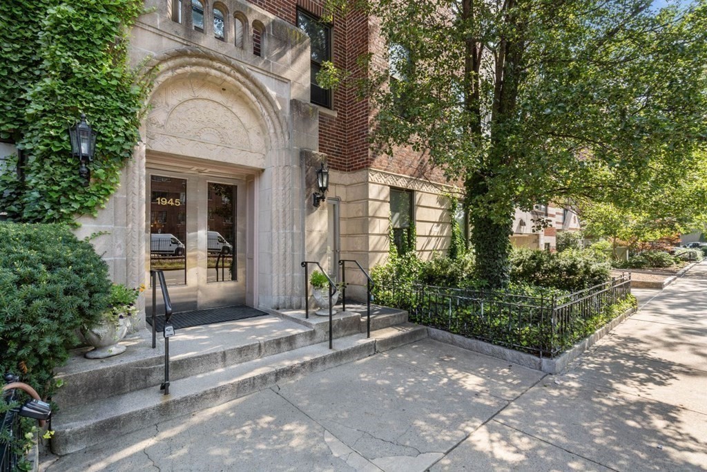 1945 Commonwealth Avenue, Unit 4 Boston, MA 02135 - Photo 1 of 22 a view of a brick house with plants and large tree