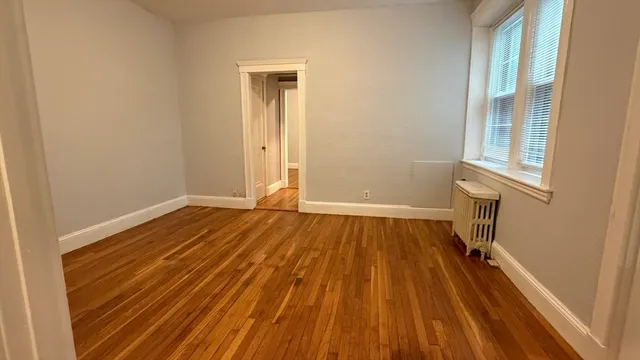 a view of a room with wooden floor and a sink