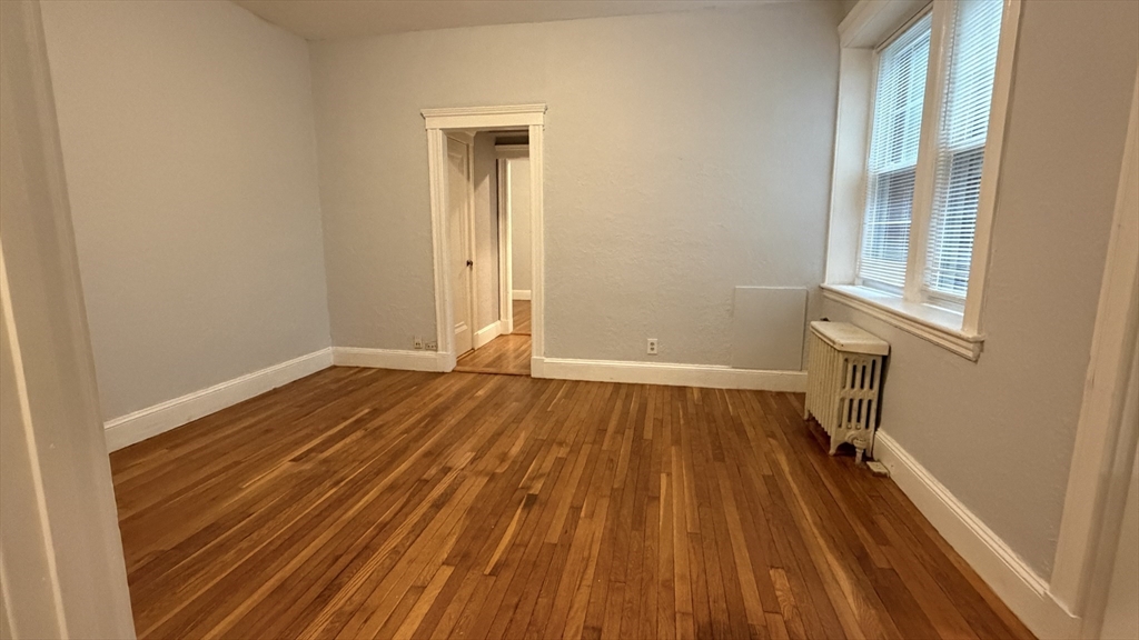 1945 Commonwealth Avenue, Unit 4 Boston, MA 02135 - Photo 13 of 22 a view of a room with wooden floor and a sink