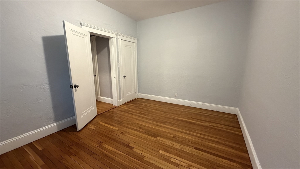 1945 Commonwealth Avenue, Unit 4 Boston, MA 02135 - Photo 14 of 22 a view of empty room with wooden floor