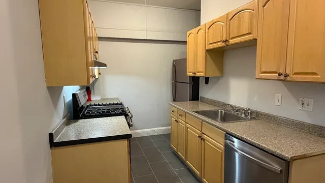 a kitchen with a sink and a refrigerator