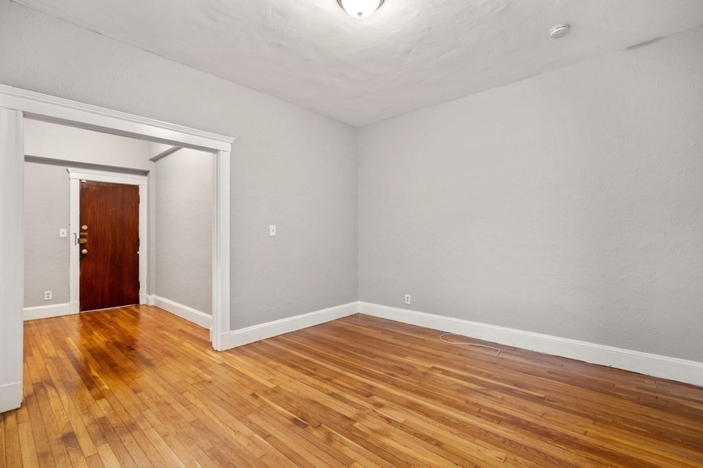 1945 Commonwealth Avenue, Unit 4 Boston, MA 02135 - Photo 7 of 22 wooden floor in an empty room