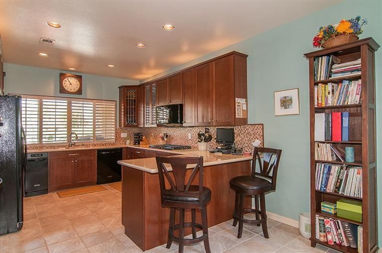 138 Lakeshore Drive Rancho Mirage, CA 92270 - Photo 13 of 24 a kitchen with stainless steel appliances granite countertop a stove a sink dishwasher and a refrigerator