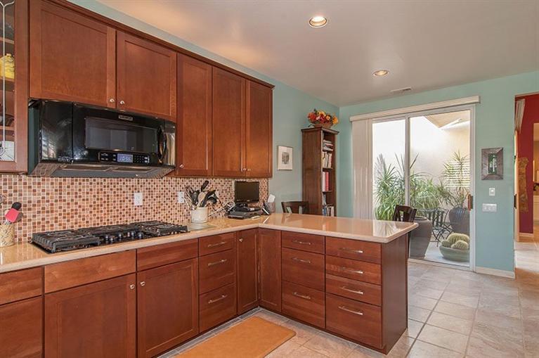 138 Lakeshore Drive Rancho Mirage, CA 92270 - Photo 14 of 24 a kitchen with a sink window and cabinets