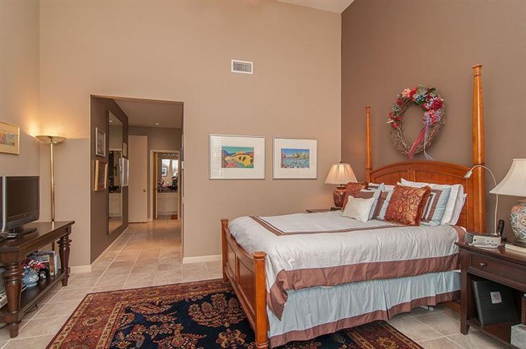 138 Lakeshore Drive Rancho Mirage, CA 92270 - Photo 18 of 24 a bedroom with a bed and a flat screen tv