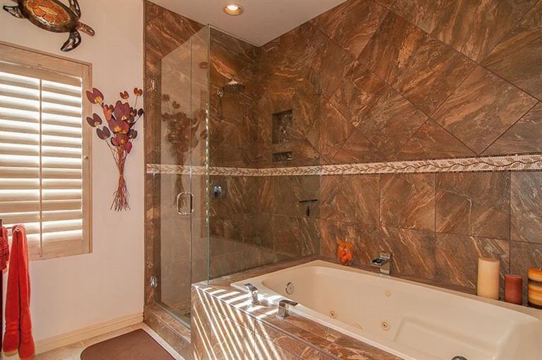138 Lakeshore Drive Rancho Mirage, CA 92270 - Photo 20 of 24 a bathroom with a bathtub and shower