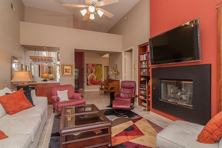 138 Lakeshore Drive Rancho Mirage, CA 92270 - Photo 4 of 24 a living room with furniture a flat screen tv and a fireplace