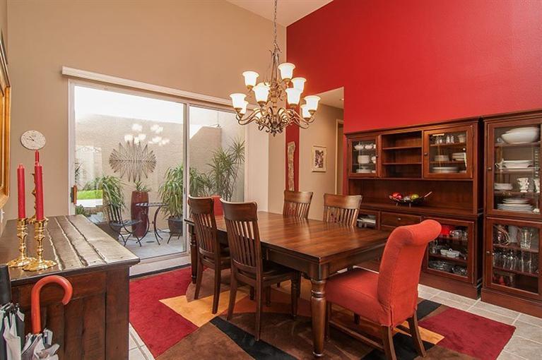 138 Lakeshore Drive Rancho Mirage, CA 92270 - Photo 9 of 24 a dining room with furniture a chandelier and wooden floor