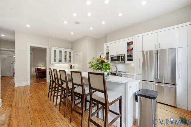 a living room with furniture fireplace and a large window