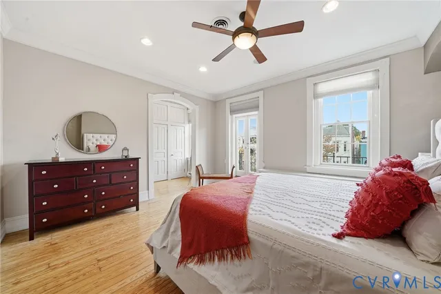 a bedroom with bed and a chandelier