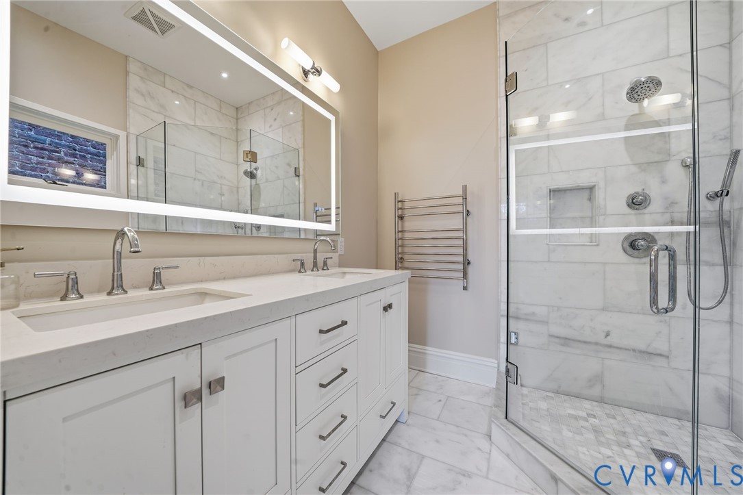 2005 Stuart Avenue Richmond, VA 23220 - Photo 25 of 29 a spacious bathroom with a shower sink and mirror