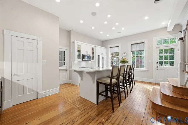 a dining room with furniture and wooden floor