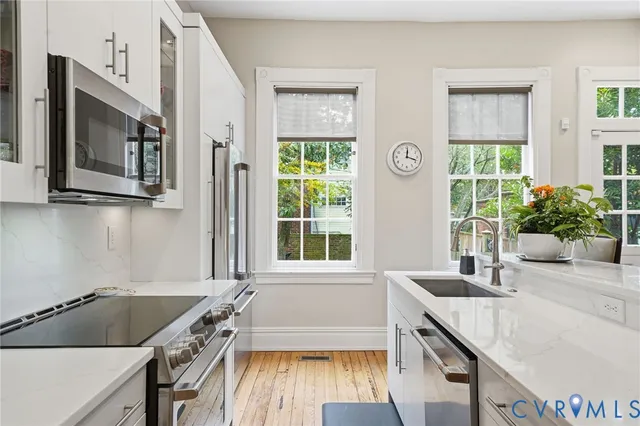 a kitchen that has a sink and a stove in it