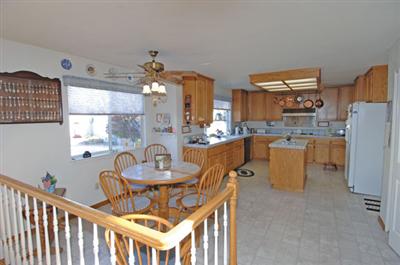 463 Noonan Ranch Lane Santa Rosa, CA 95403 - Photo 4 of 10 a dining room with furniture a chandelier and kitchen view