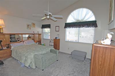 463 Noonan Ranch Lane Santa Rosa, CA 95403 - Photo 8 of 10 a bed room with a bed and a chandelier