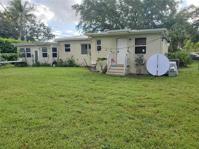 a front view of house with yard and trees