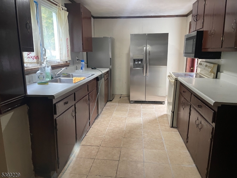 60 Vail Road Blairstown, NJ 07832 - Photo 17 of 26 a kitchen with kitchen island granite countertop a sink stove and refrigerator